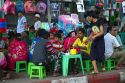 Burmese people eat and drink at small tables and chairs outdoors in (Rangoon) Yangon, (Burma) Myanmar.