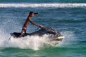 Man riding a personal water craft in the Gulf of Thailand at Chaweng beach on the island of Ko Samui, Thailand.