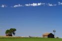 Barn and windmill on farmland near Dalhart, Texas, USA.