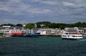 Lakefront historic buildings and ferry boat on Mackinac Island located in Lake Huron, Michigan, USA.