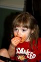 Two year old girl eating spaghetti and getting it all over her face, Tampa, Florida, USA.