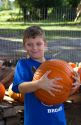 Eight year old boy choosing a pumpkin for halloween near Tampa, Florida, USA.