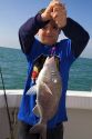 Eight year old boy fishing in the Gulf of Mexico off the coast of Florida, USA.