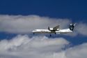 Alaska airlines Bombardier Q400 commuter airplane in flight.