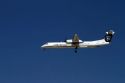 Alaska airlines Bombardier Q400 commuter airplane in flight.