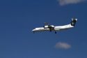 Alaska airlines Bombardier Q400 commuter airplane in flight.