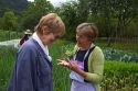 American tourist and Spanish woman talk about gardening in the municipality of Cangas de Onis in Asturias, Spain.