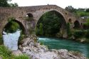 Arched Roman Bridge spanning the Sella River in the municipality of Cangas de Onis in Asturias, Spain.