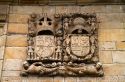 Coat of arms carved in the stone wall of the Hotel los Infantes at Santillana del Mar, Cantabria, Spain.