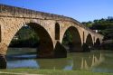 Six-arched Roman bridge spanning the Arga River on the Way of St. James pilgrimage route in Puente La Reina, Navarra, Spain.