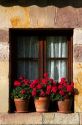 Flower pots in the window of a building in the village of Santillana del Mar, Cantabria, Spain.