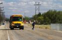 A school bus stopped with flashing red lights and stop sign allowing a child to get off in Canyon County, Idaho, USA.