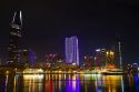 Night view of city lights reflected on the Saigon River in Ho Chi Minh City, Vietnam.
