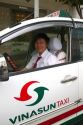 Vina Sun taxi and driver in Ho Chi Minh City, Vietnam.
