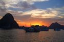 Tour boats at sunset in Ha Long Bay, Vietnam.