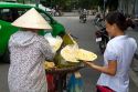 Vietnamese street vendor selling durian fruit in Hanoi, Vietnam.