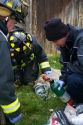 Firefighters revive a dog with oxygen rescued from a house fire in Boise, Idaho, USA.