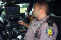 Florida state trooper using computer in patrol car.