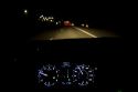 Driver's eye view of dashboard and highway at night in Ada County, Idaho, USA.